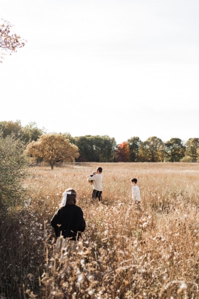Rachel Wallace Morse and family walking through a golden autumn field